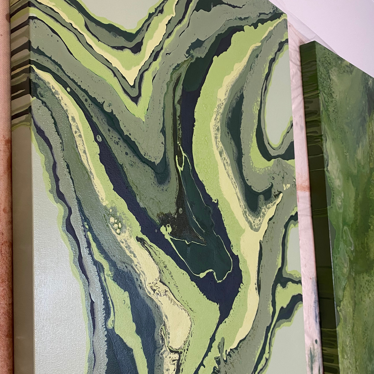 Abstract fluid art canvas print featuring swirling marbled patterns in shades of sage green, olive, dark forest green, cream, and charcoal gray.